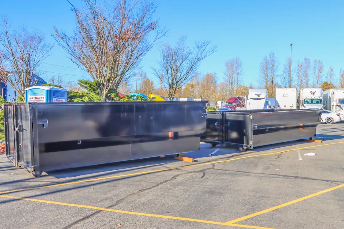 Professional dumpster rental service with roll-off container on residential driveway in Upper Moreland